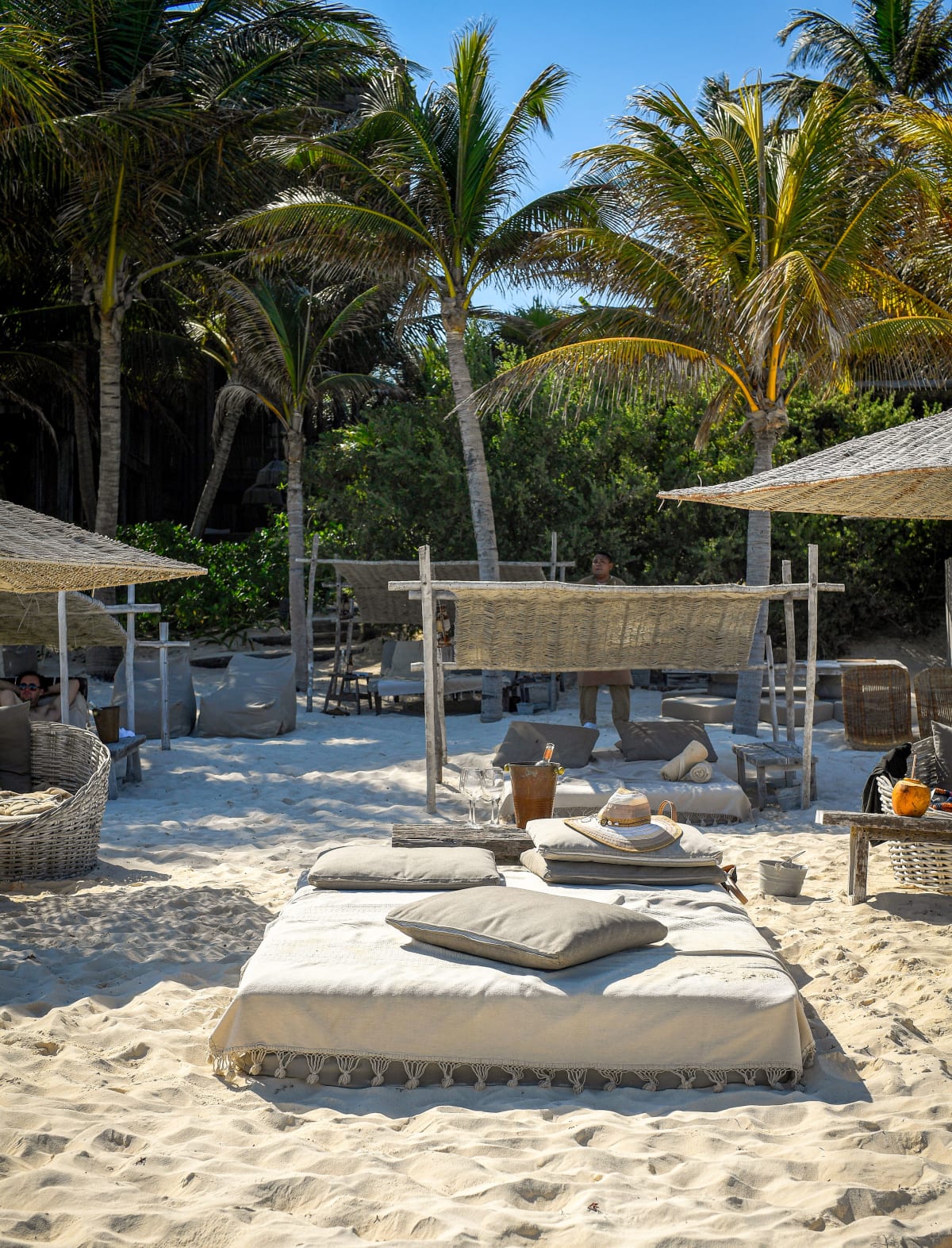 Luxurious beachside retreat with palapas and daybeds in Tulum, Mexico, the boutique development driving prices Puerto Escondido has not reached