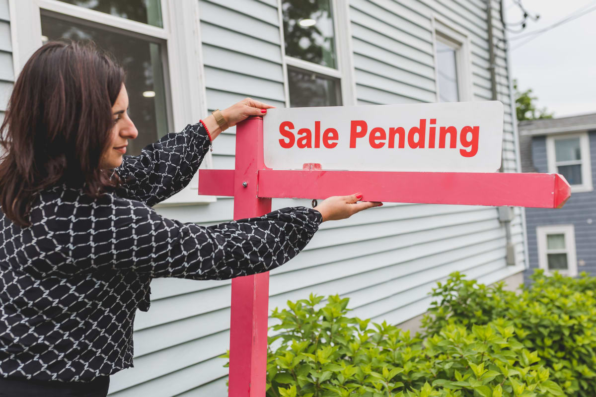 Real estate agent holding a signage — rising buyer demand in Puerto Escondido since the Barranca Larga highway opened