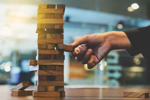 Man taking out block from jenga 