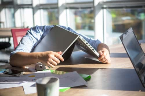 Man under laptop