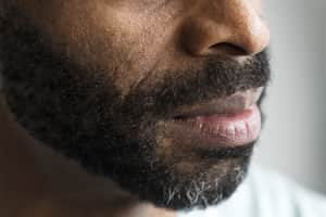 bearded man looking to one side 