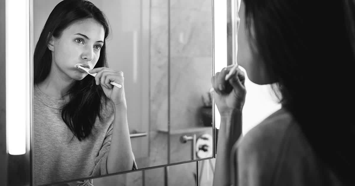 woman brushing teeth