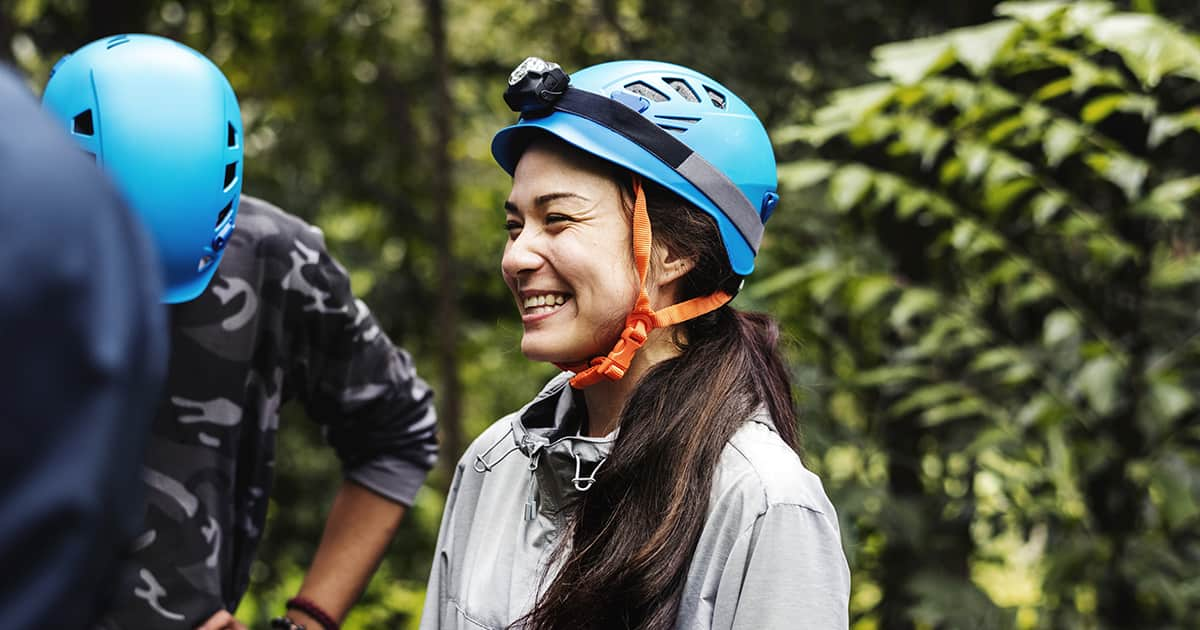 woman smiling in the jungle while doing adventure sports