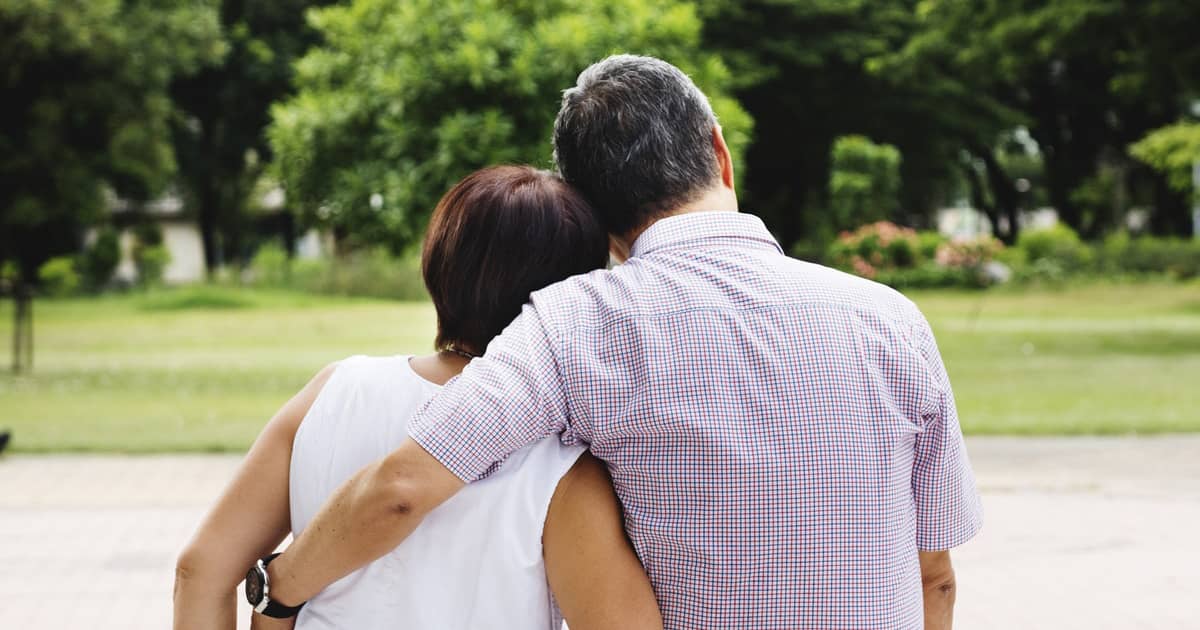 elderly couple hugging