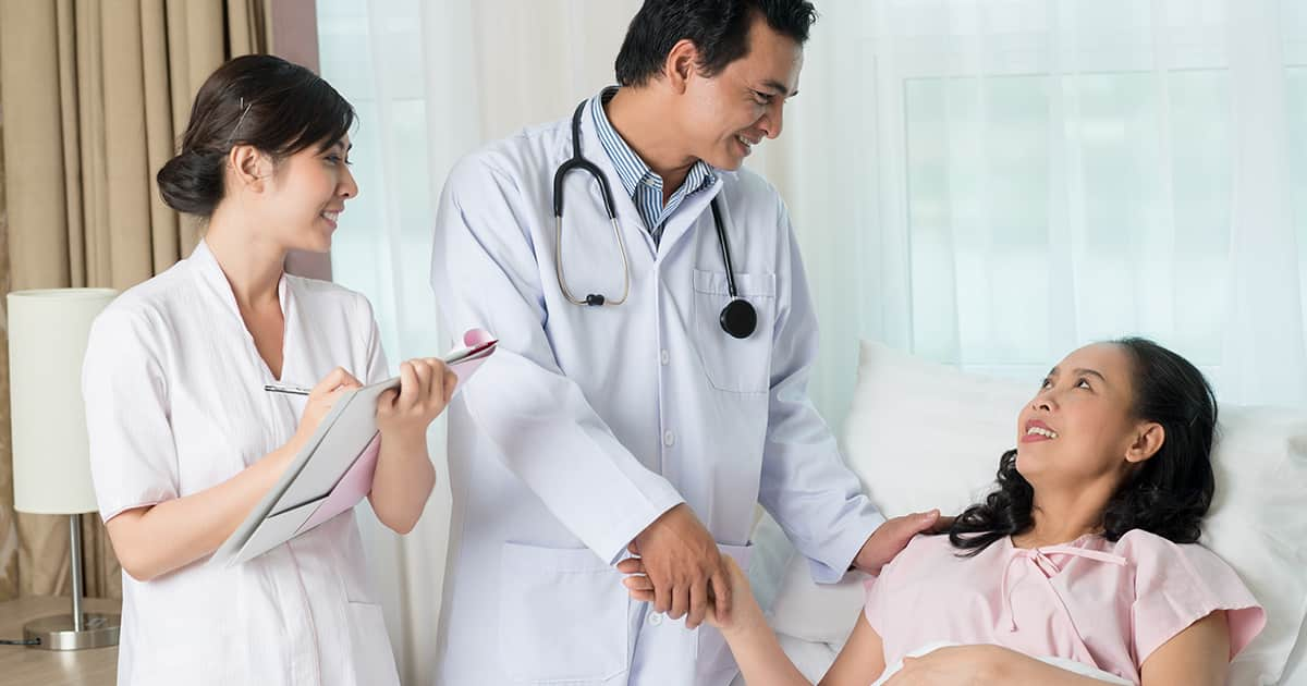 a nurse and doctor comforting a patient