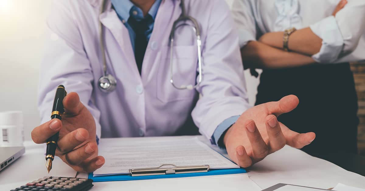 a doctor talking at his desk