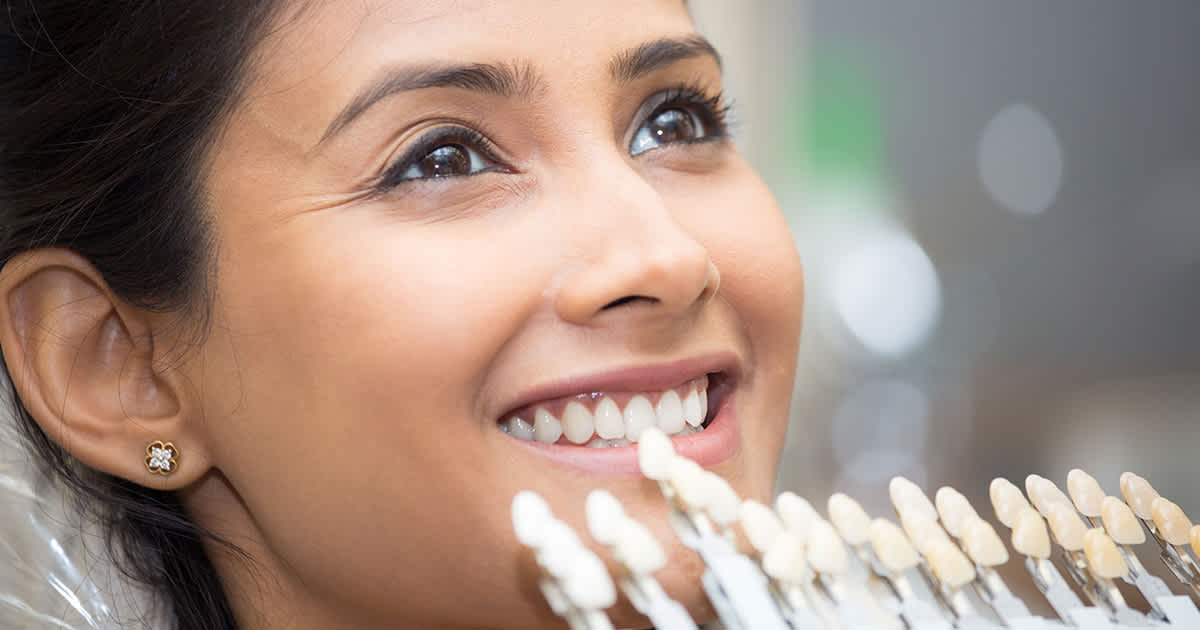 woman smiling as she gets fitted for veneers