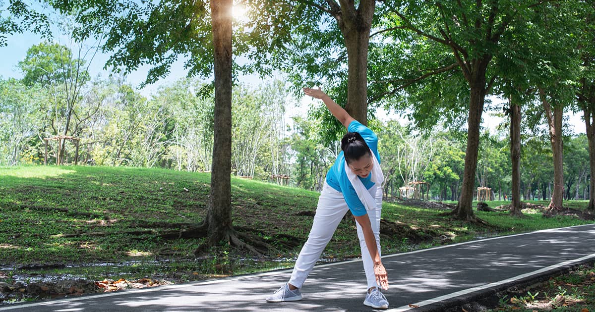 a woman exercising in a park