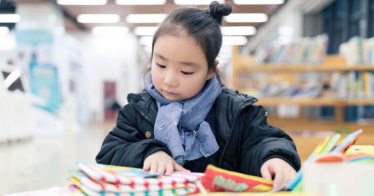 little asian girl reading