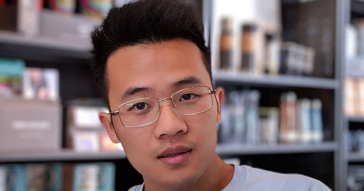 a young man with glasses