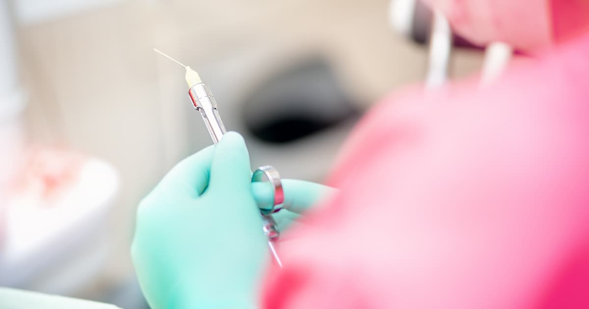 a dentist preparing local anaesthesia