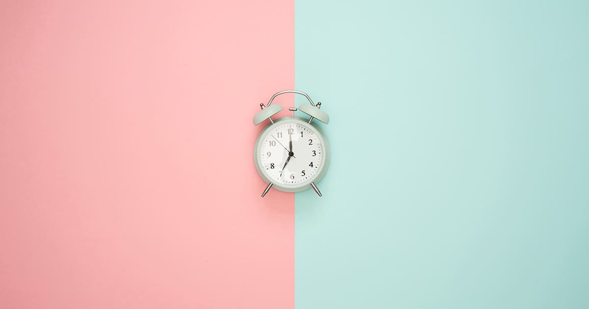 a clock against a pastel background