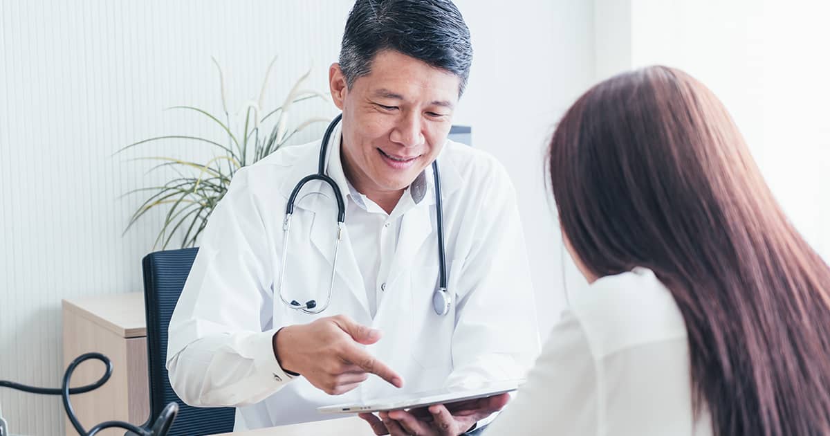 a woman talking to a doctor in a clinic