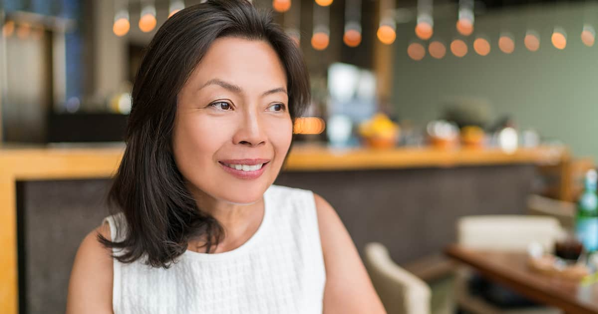 woman smiling in a restaurant