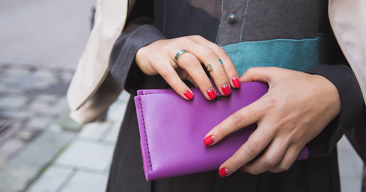 a woman holding a purple purse