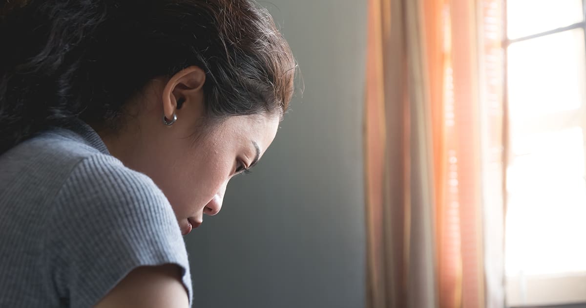 a woman looking down in a room