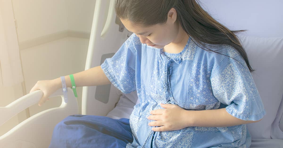 a pregnant woman in a hospital bed