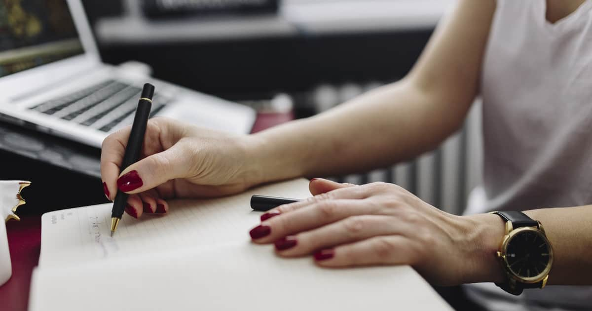 woman writing on paper