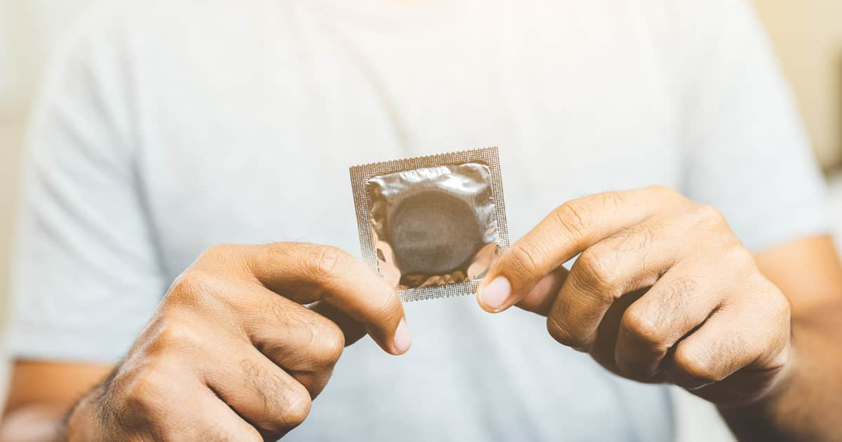 a man holding a condom