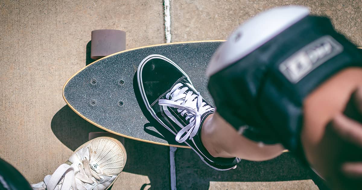 skater on a skateboard with knee guard