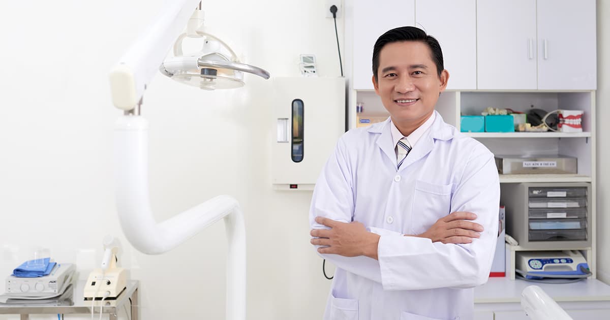 a dentist smiling in his clinic