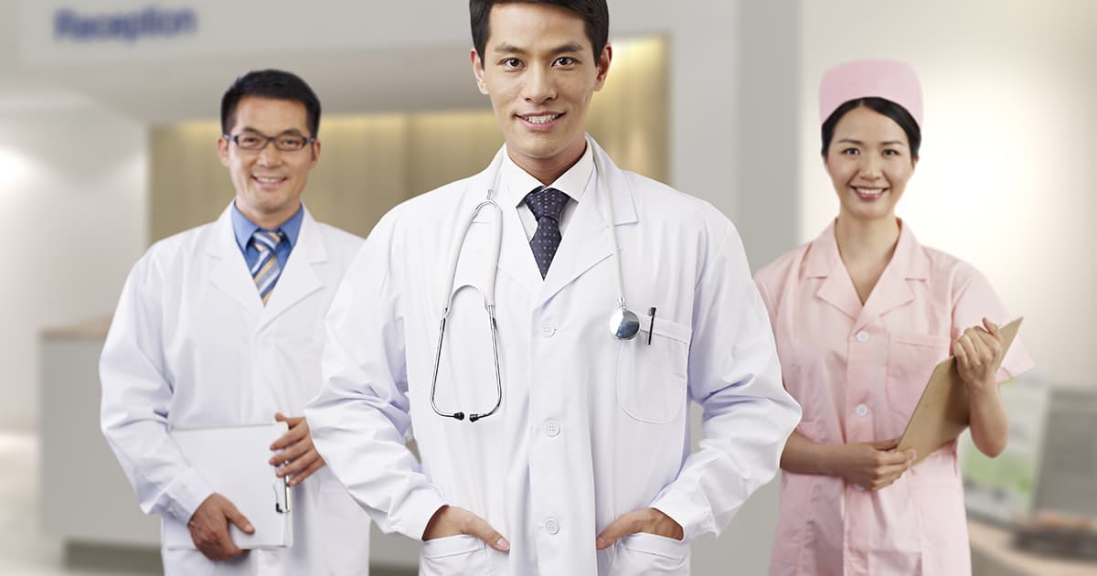 doctors posing in a clinic with a nurse