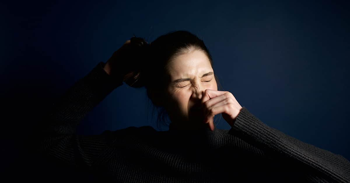 woman sneezing