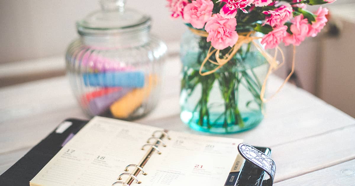 a diary on table with flowers