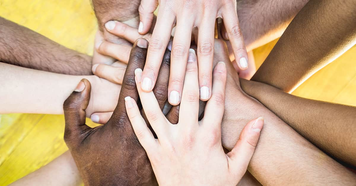 a group of multiethnic friends' hands