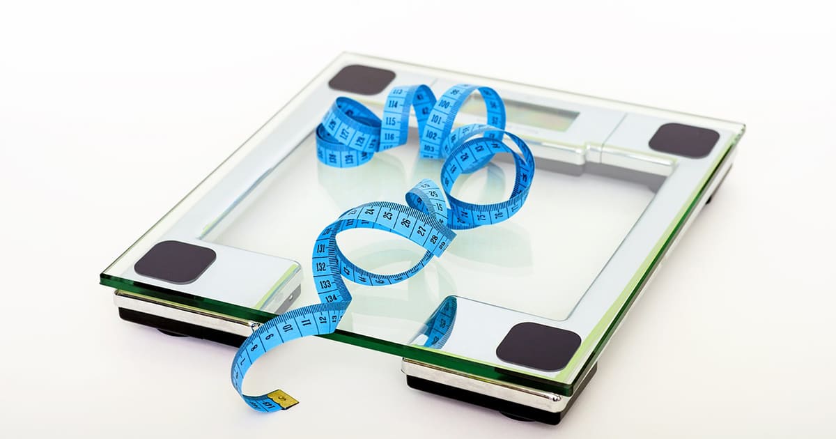 a weighing scale with measuring tape