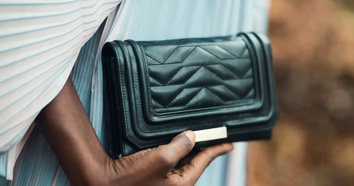 womans hand with wallet