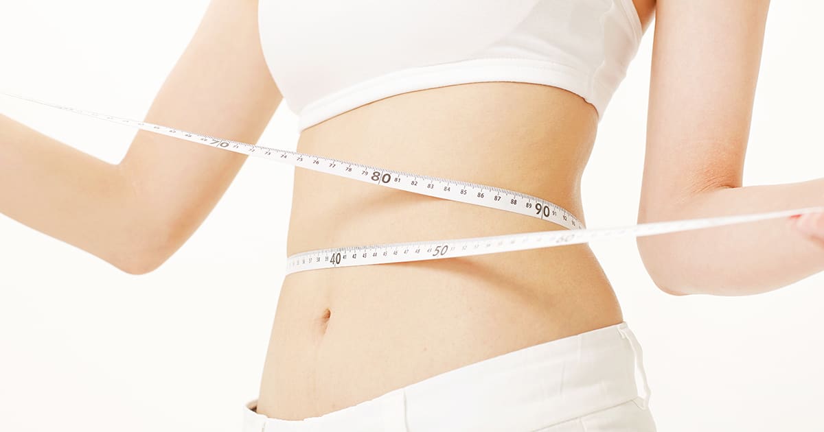 a woman wearing white clothes and holding measuring tape