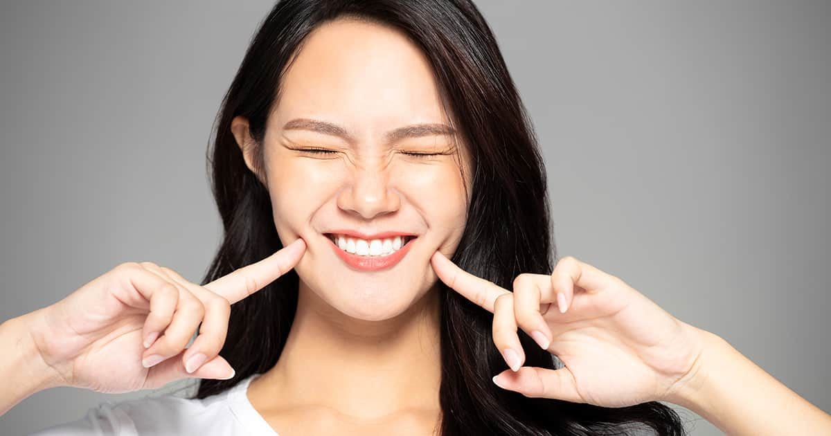 young asian woman smiling with teeth