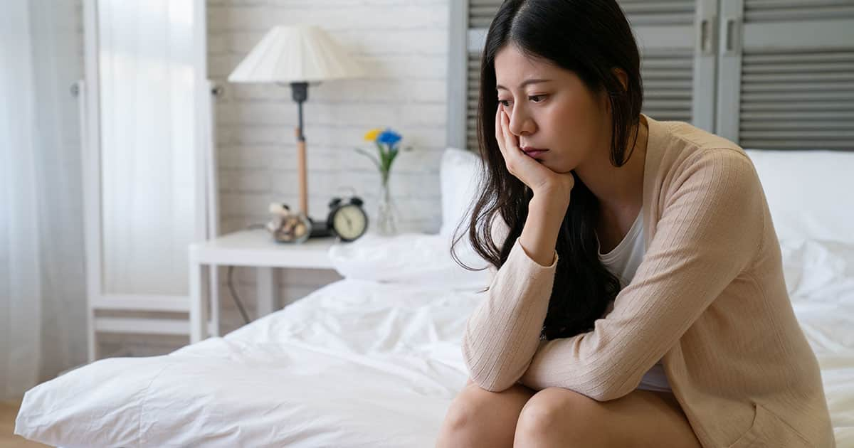 worried adult on the bed