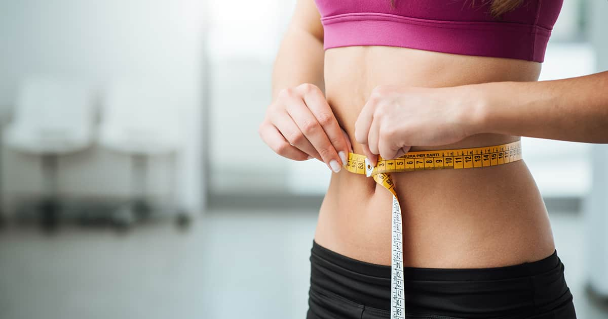 asian woman with measuring tape on waist