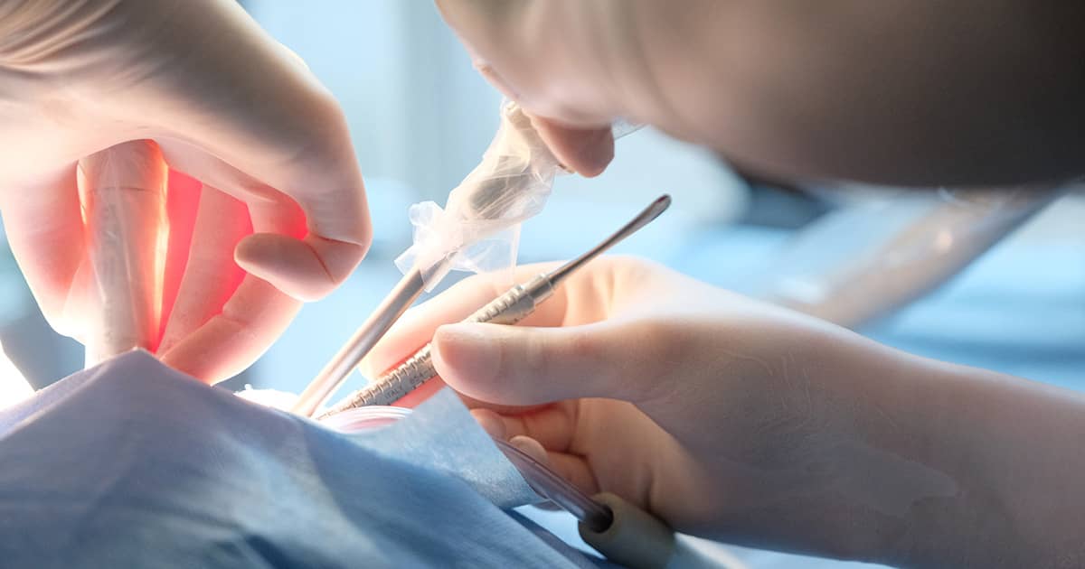 closeup on hands of surgeon during a surgery