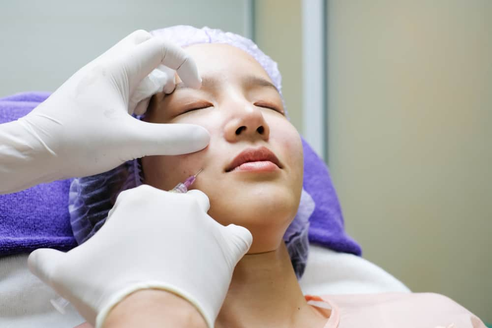 Woman getting skin healer injected into face