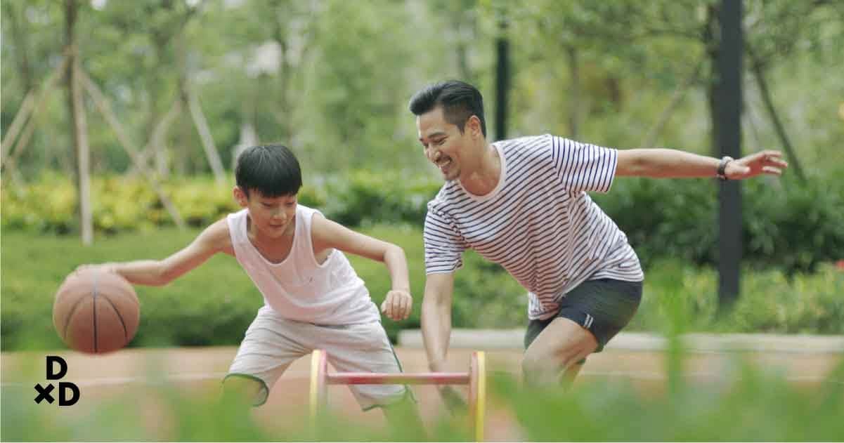 man playing basketball with son