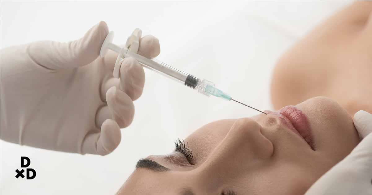 Woman getting filler injection on face