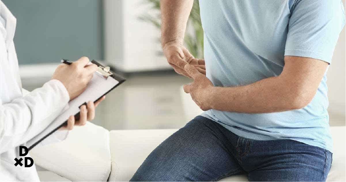 Man holding side while doctor checks him