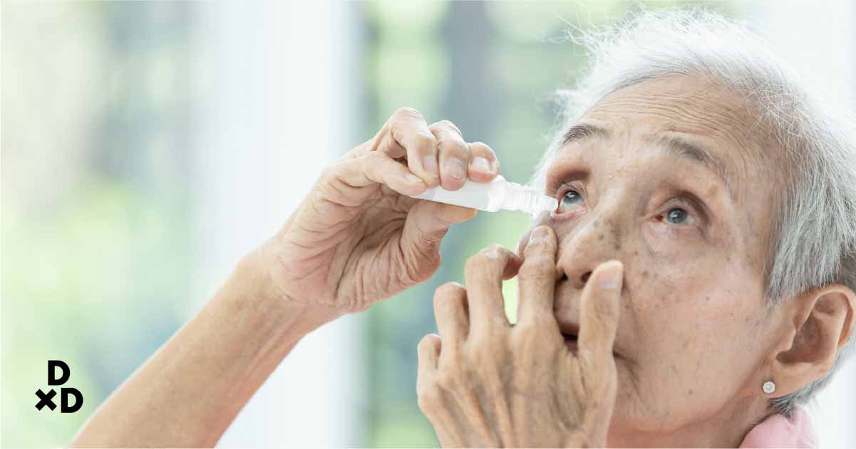 Senior applying eyedrops