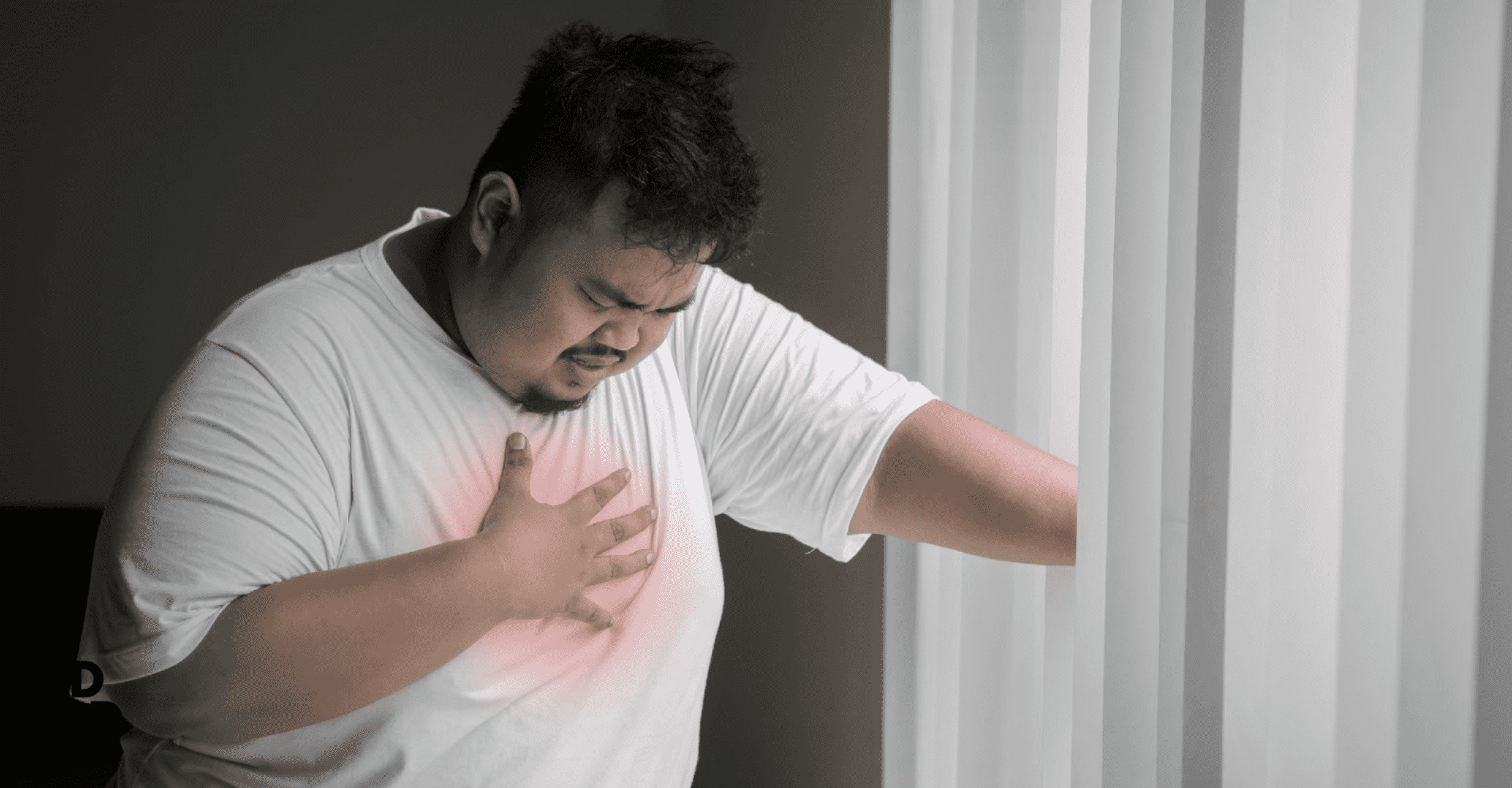 man feeling pain in chest due to obesity