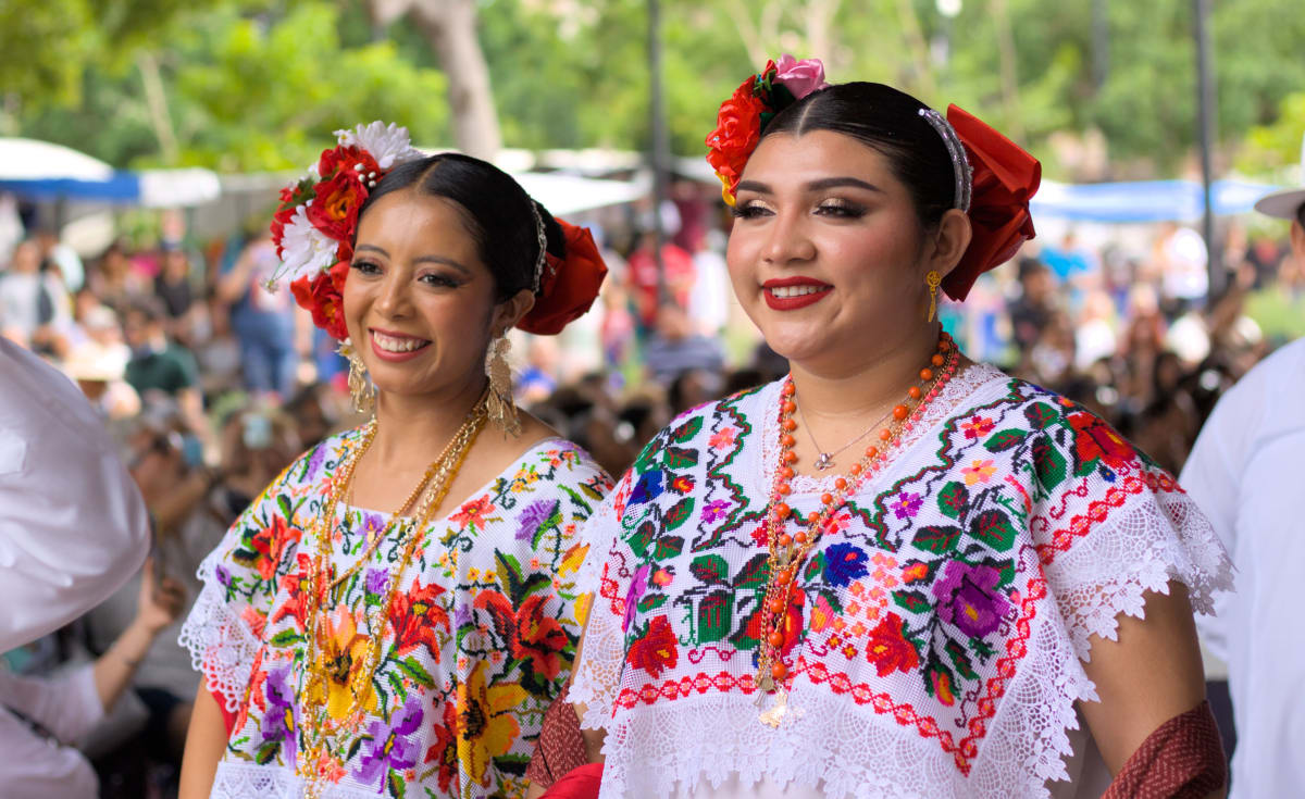 Dancers in embroidered Yucatecan terno dresses at a free cultural event in Merida, part of the Merida events 2027 calendar