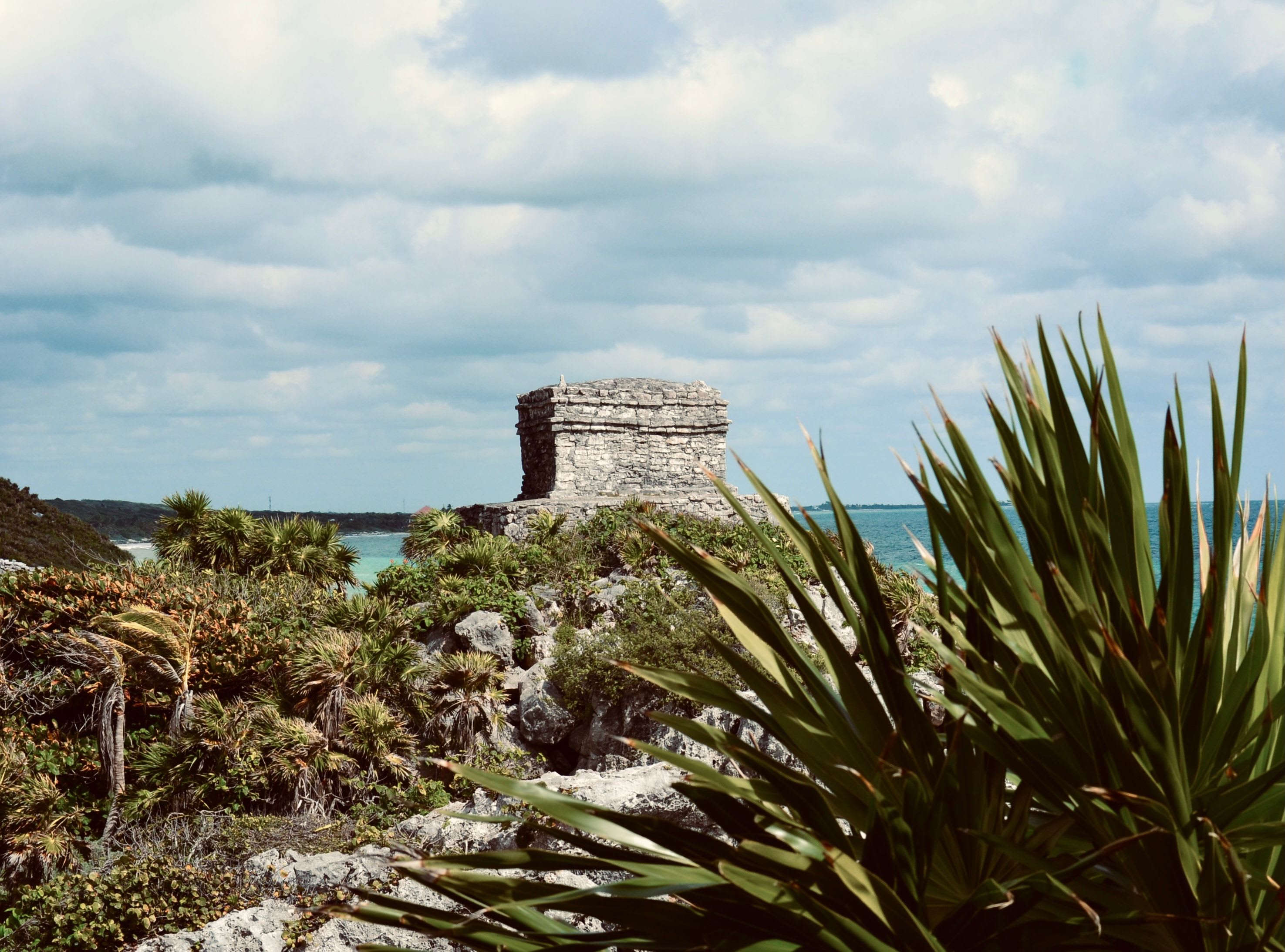 El Castillo pyramid at Tulum ruins overlooking the turquoise Caribbean at golden hour