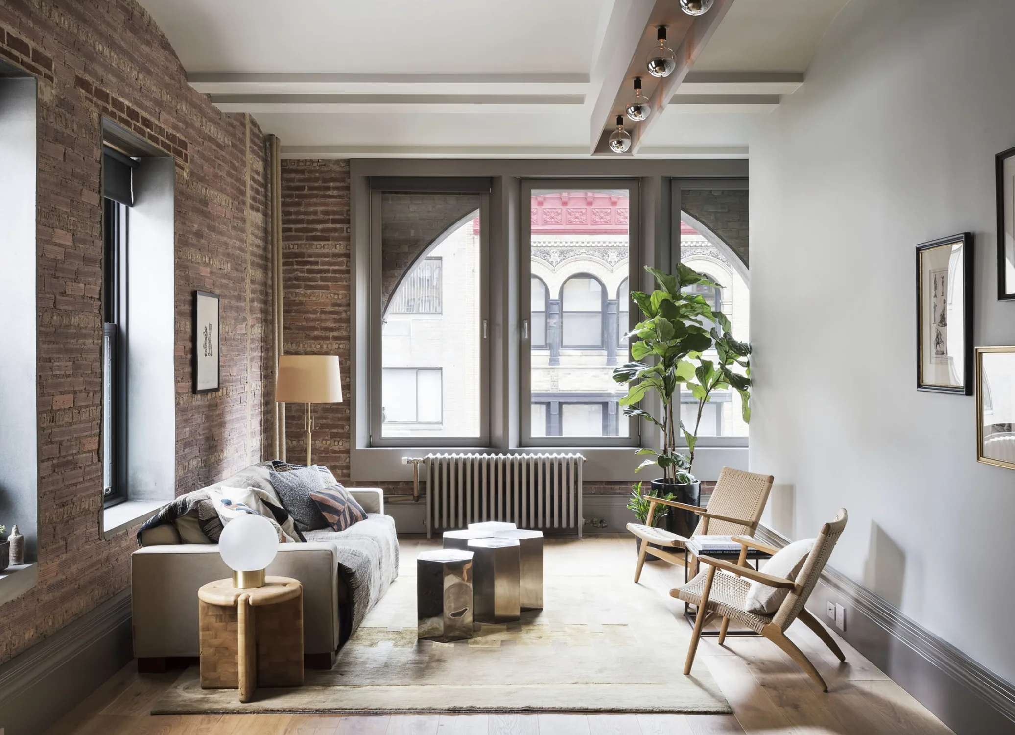 loft, brick, windows, living room,chairs, sofa,pilows, lamp,stool, plant