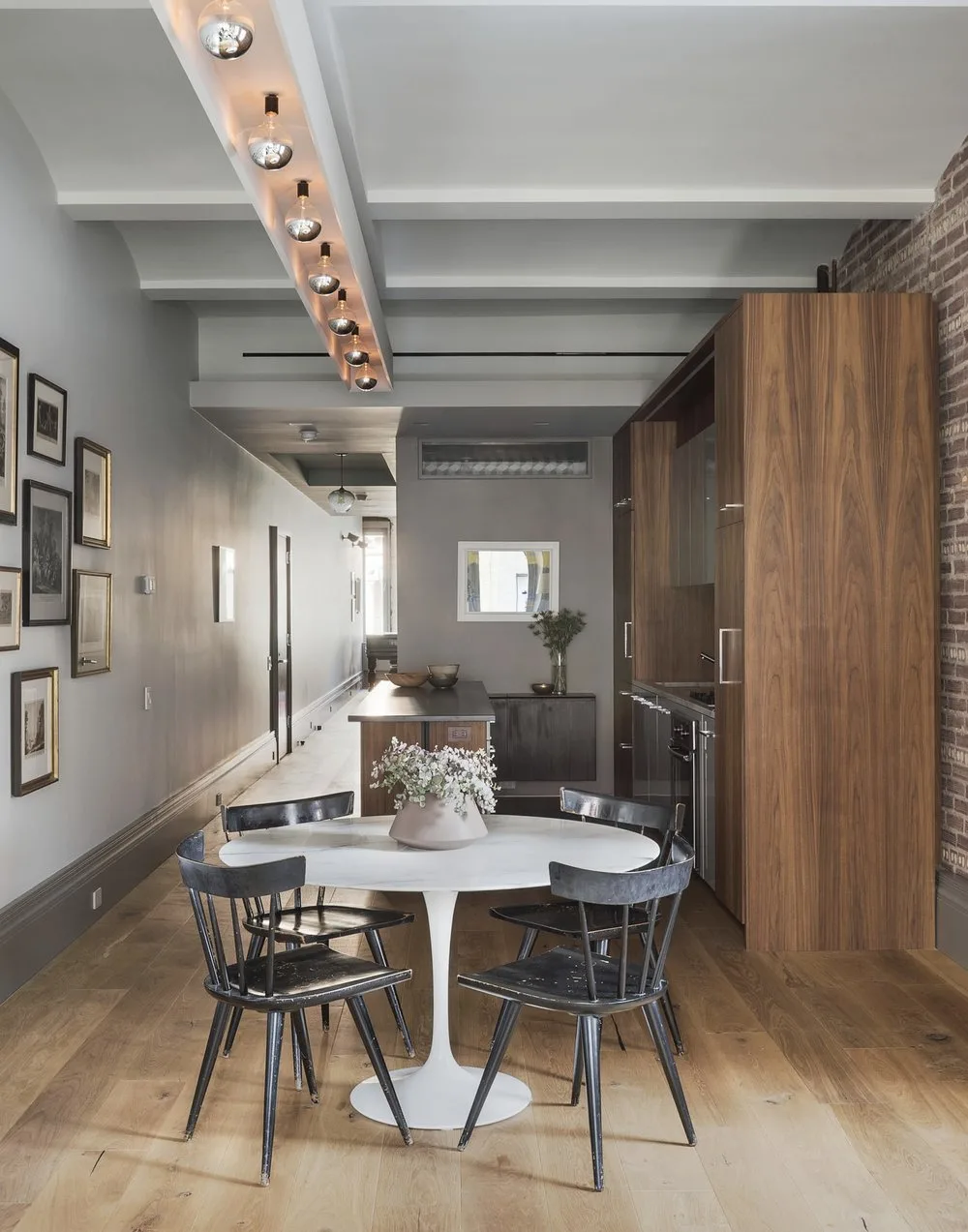 kitchen, table, wood, bricks, art frames, flowers, arches,lights, steel,door