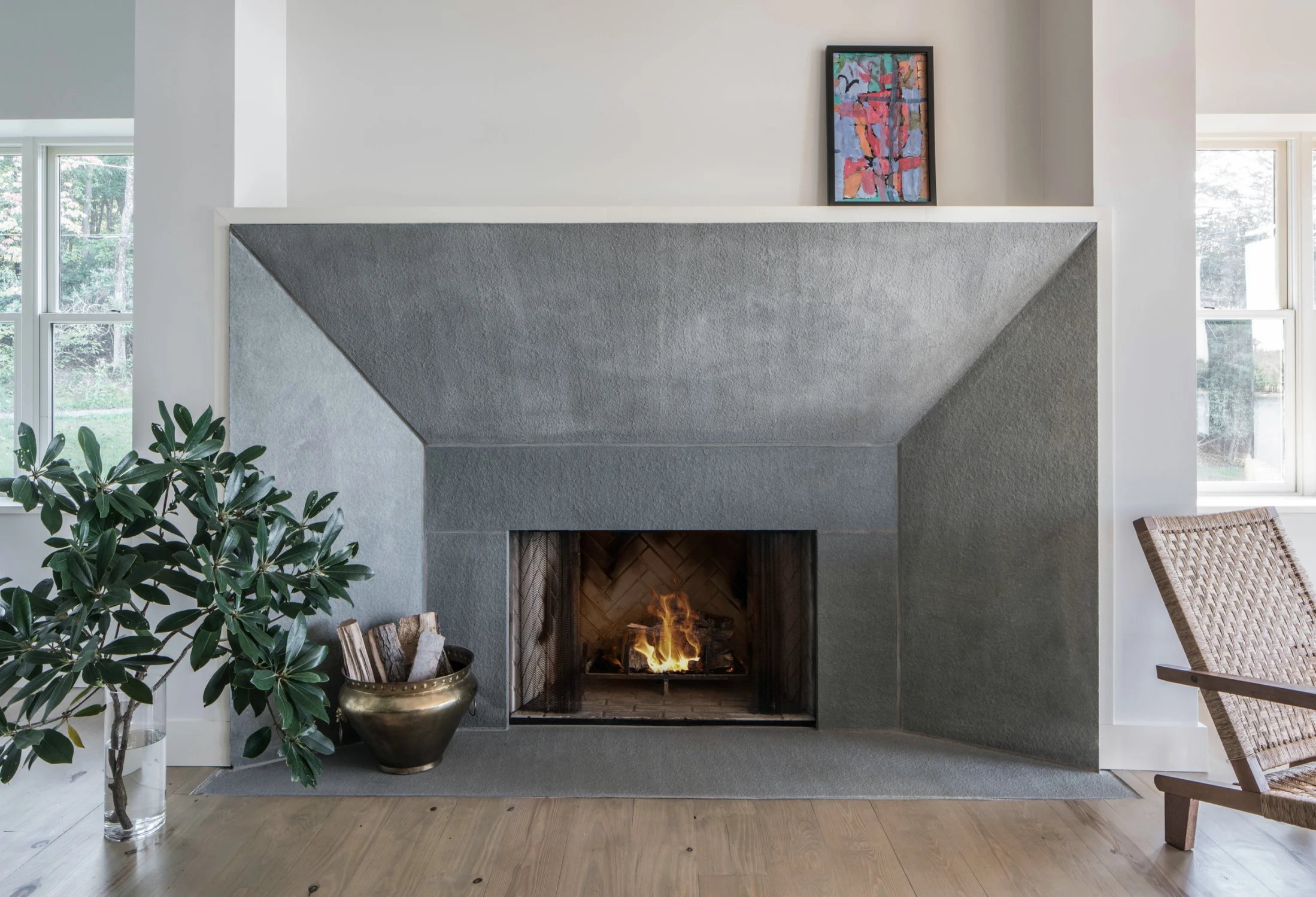 FIREPLACE, stone, wood flooring, art, plant, wood logs, copper vessel, woven chair