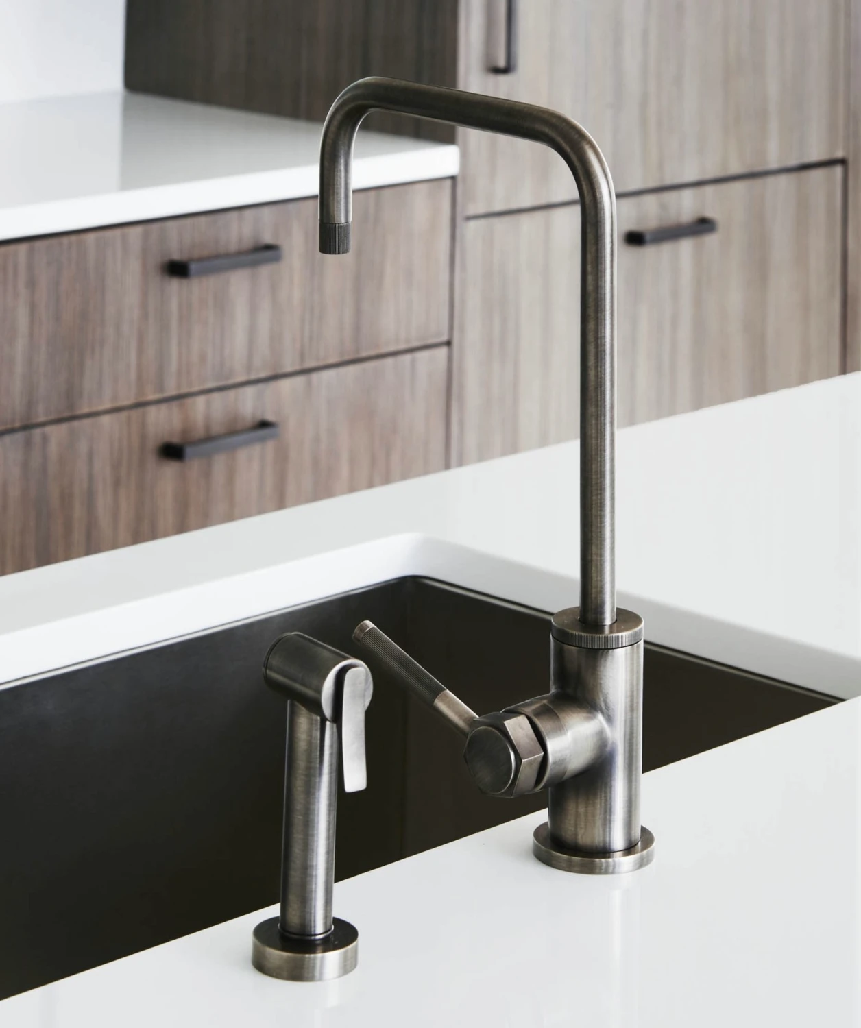 faucet, steel, wood cabinets, sink, white countertop