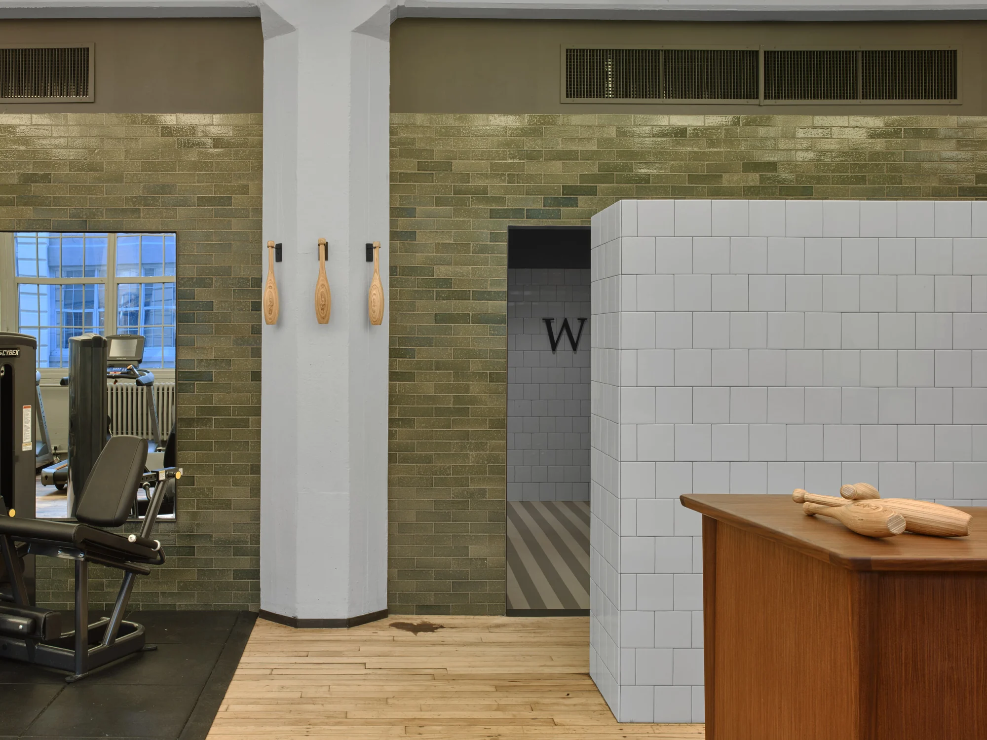 green tiles, wood floor, counter, gym equipment