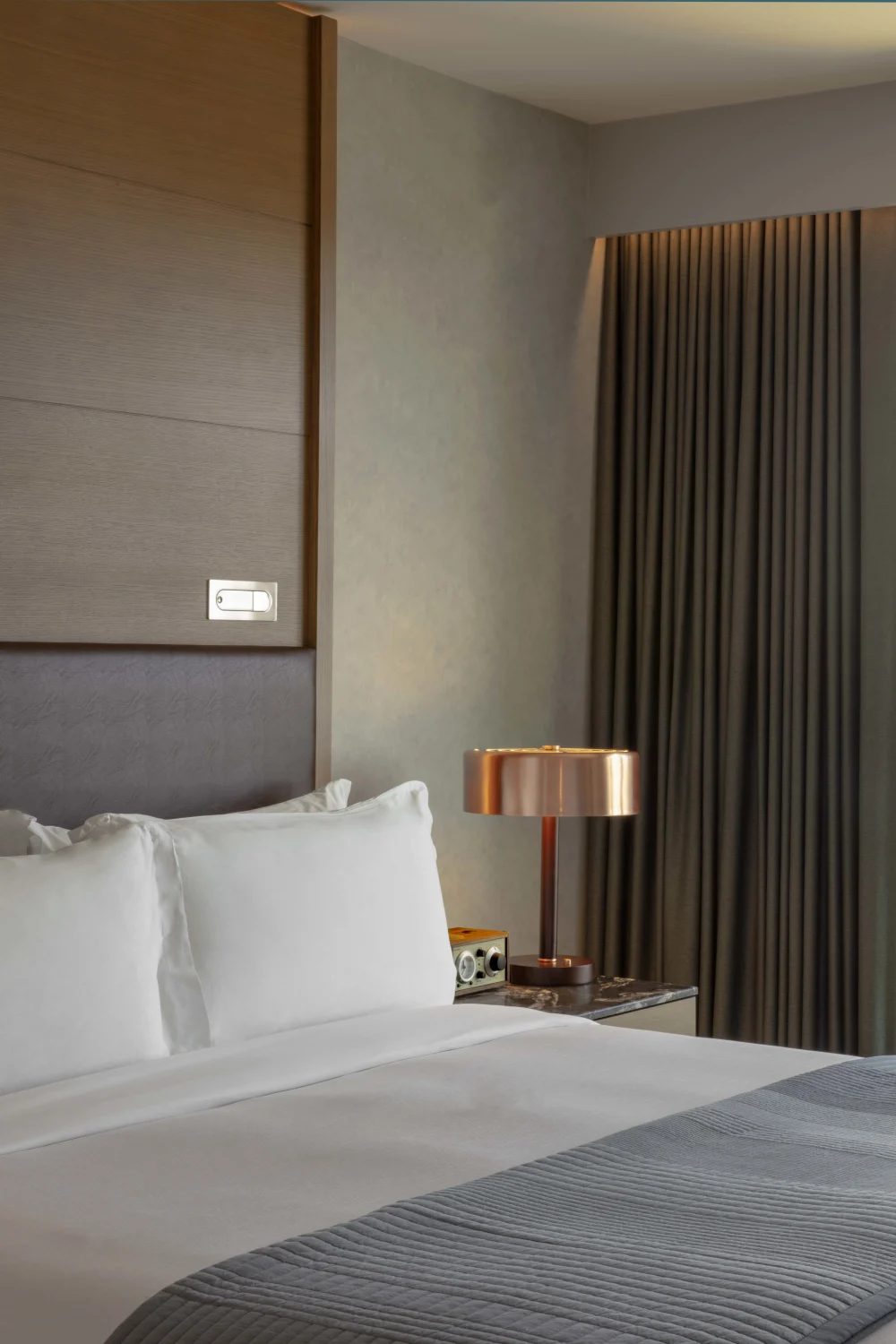 bed, headboard, side table, curtains, brass lamp